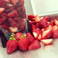Fresh strawberries, cut and whole